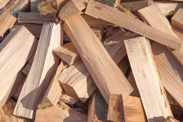 Natural wooden background, closeup of chopped firewood. Chopped firewood on a stack