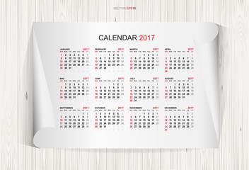 Calendar 2017 year on white paper and wooden texture background. Week starts from Sunday. Vector illustration.