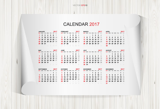 Calendar 2017 year on white paper and wooden texture background. Week starts from Sunday. Vector illustration.