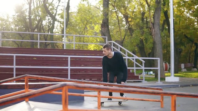 Skateboarder skateboarding and jumping flip trick over the pipe and falling down on concrete street. Skateboarder jumping kickflip trick with skateboard falling and crashing. Slowmotion shot