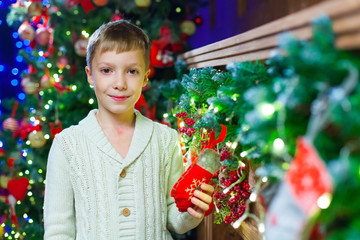 Waiting for present. Pleasant euphoric little boy and holding ha