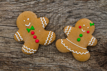 Christmas gingerbread couple cookies on rustic wooden table