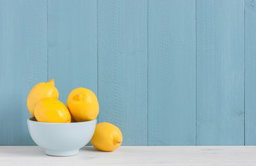 Plate with fresh lemons on the table