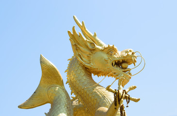 Chinese dragon statue in the mouth with glass balls On the blue sky background