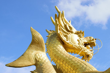 Chinese dragon statue in the mouth with glass balls On the blue sky background