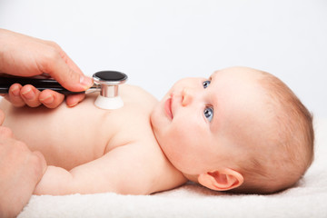 Baby medical exam - doctor checking heart beat and lungs with stethoscope