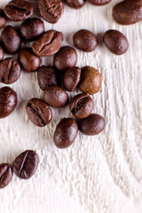 Coffee beans or grain on white wooden background. Flat lay.