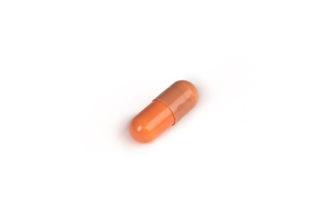 close-up of a brown pill isolated on a white backgound.psd