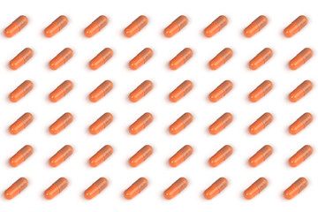 many brown pills isolated on a white background