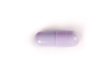 close-up of a purple pill from above isolated on a white background.psd