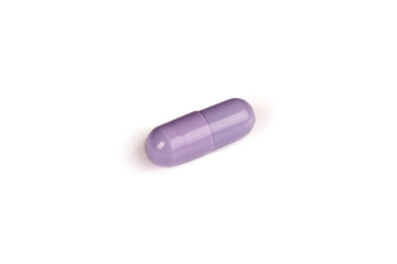 close-up of a purple pill isolated on a white backgound.psd