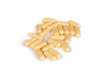 some yellow pills isolated on a white background