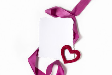 Blank sheet of paper. Heart and pink ribbon on a white background