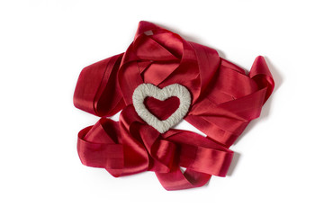 On a white background red ribbon and heart handmade