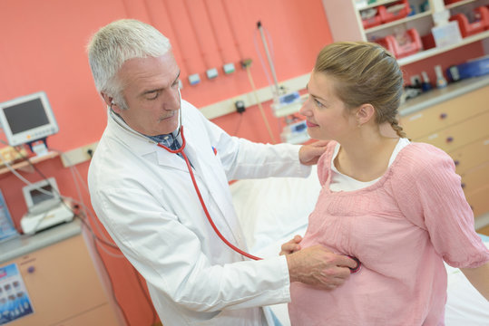 healthy pregnant woman at examination in doctor-gynecologist