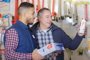 men selecting a product in a hardware store