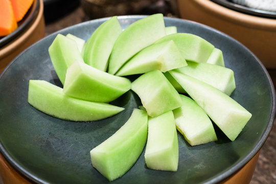 sliced melons on plate
