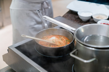 chef cooking spaghetti