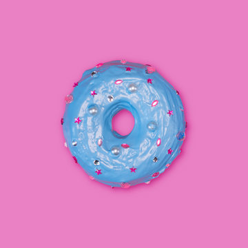 A photo of a donut, decorated with caramel, which looks like rhinestones