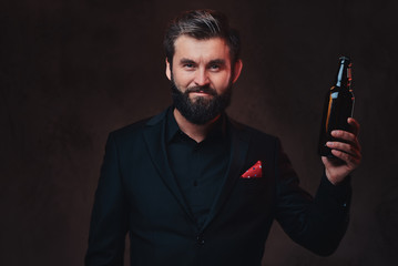 A man in a black suit presenting craft beer.