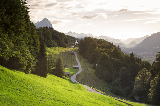 The iconic Wamberg Church, with Mount Alpspitze and Zugspitze on the background. Wamberg, Garmisch Partenkirchen, Bayern, Germany