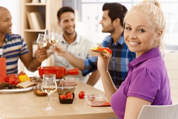 Happy woman dining with friends