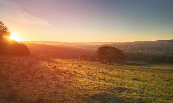 Red, Orange And Yellow Glow Of A Sunset Over Green Pastures And Trees In The English Countryside. Gibside  Near Newcastle Upon Tyne.