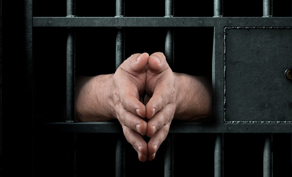 Jail Cell Door And Hands