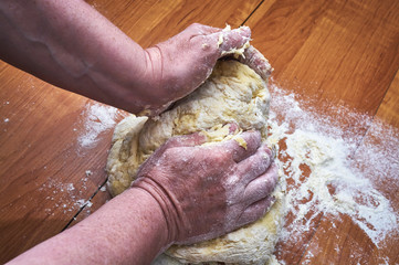 woman's hands knead the dough for croissants