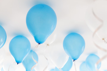 blue balloons under white ceiling