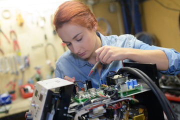 Fototapeta na wymiar pretty woman repairing electronic chip