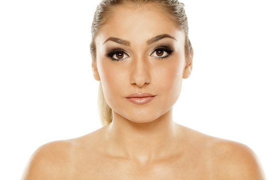 Portrait of beautiful young woman with makeup on white background