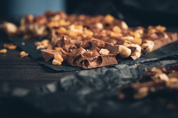 Obraz na płótnie Canvas milk chocolate with nuts pieces