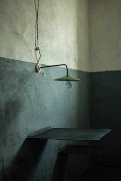 Lamp, table and chair in jail cabin