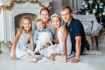 Happy family near Xmas tree