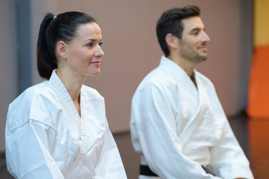 female and male karatekas during lesson