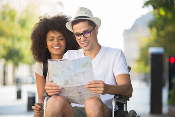 young man on the wheelchair holding a map