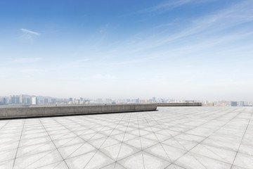 empty brick floor with modern cityscape in foggy day