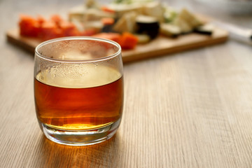 Hot tea in a glass, in backlight, against the background of products.