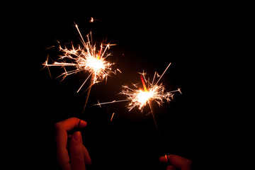 Sparkler background / A sparkler is a type of hand-held firework that burns slowly while emitting...