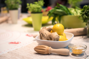 Ginger with lemon in bowl with turmeric ready for healthy beverage preparation 