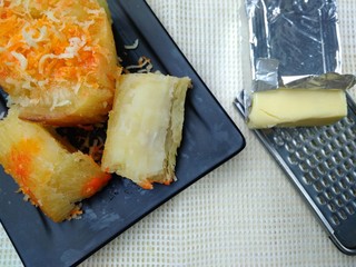 Singkong Keju, Indonesia Traditional Snack Food, made from Steamed Cassava and grated Cheese and Chili Powder for Topping