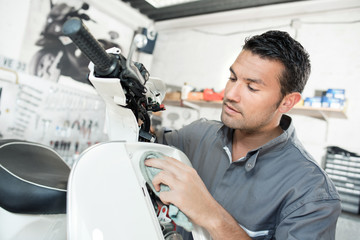 worker polishing scooter