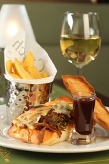 Bistro meal with rich sandwich, fries, beverage