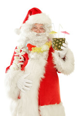 Series of Santa Claus isolated on White Cut out: Happy Santa enjoying a tropical Vacation with Ananas Cocktail