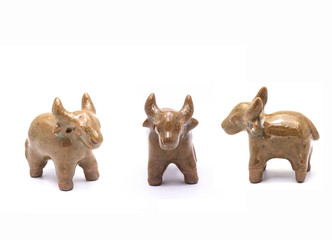 Buffalo made of baked clay on white background.