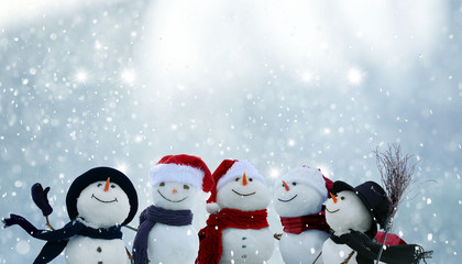 Merry Christmas and happy New Year greeting card with copy-space.Many snowmen standing in winter Christmas landscape.Winter background