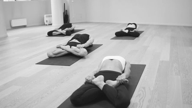 Yoga class. People doing yoga exercises