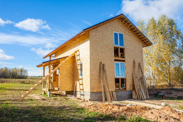 Fototapeta na wymiar frame house under construction in the village