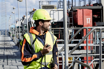 Dude in hardhat working on docks, looking away